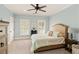 Bedroom with soothing blue walls, a comfortable bed, and natural light exudes comfort and tranquility at 554 Parrot Point Dr, Charleston, SC 29412