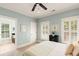 Bedroom with serene blue walls, plantation shutters, and an ensuite bathroom is perfect for relaxation at 554 Parrot Point Dr, Charleston, SC 29412