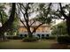Charming two-story home with a red roof and a sprawling front yard at dusk at 554 Parrot Point Dr, Charleston, SC 29412