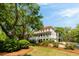 Gorgeous two-story home boasts a red roof, lush landscaping, and a sprawling front lawn at 554 Parrot Point Dr, Charleston, SC 29412