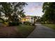 Beautiful two-story home with a large driveway, mature trees, and landscaped lawn at 554 Parrot Point Dr, Charleston, SC 29412