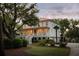 Elegant two-story home with a charming porch, well-maintained landscaping, and mature trees at 554 Parrot Point Dr, Charleston, SC 29412