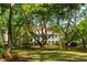 Charming home with a classic design, surrounded by mature trees and a sprawling lawn at 554 Parrot Point Dr, Charleston, SC 29412