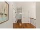 Hallway with hardwood floors, shiplap walls, and neutral paint offers a warm and inviting transition between rooms at 554 Parrot Point Dr, Charleston, SC 29412