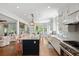 Modern kitchen features a large island with seating, granite countertops, stainless steel appliances, and abundant natural light at 554 Parrot Point Dr, Charleston, SC 29412
