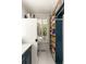 Functional laundry room with stacked washer/dryer, plenty of shelving, and a window offering natural light at 554 Parrot Point Dr, Charleston, SC 29412