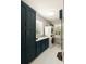 Well-organized laundry room with custom cabinetry, ample counter space, and a stacked washer and dryer for convenience at 554 Parrot Point Dr, Charleston, SC 29412