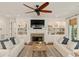 Spacious living room featuring a brick fireplace, built-in shelving, and comfortable white sofas with stylish accents at 554 Parrot Point Dr, Charleston, SC 29412