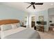 Light-filled Primary bedroom with a woven headboard, desk, and access to the ensuite bathroom at 554 Parrot Point Dr, Charleston, SC 29412