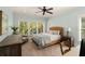 Bright Primary bedroom with a woven headboard, desk, and natural light from large windows at 554 Parrot Point Dr, Charleston, SC 29412