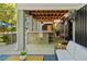 Covered outdoor bar area with a stone facade, overhead fans, and a view of the backyard at 554 Parrot Point Dr, Charleston, SC 29412