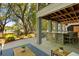 Relaxing outdoor living area with a covered bar, lounge seating, and backyard views at 554 Parrot Point Dr, Charleston, SC 29412