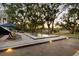 Stunning pool area with lounge chairs, bocce court, and elegant landscaping perfect for relaxation and outdoor enjoyment at 554 Parrot Point Dr, Charleston, SC 29412