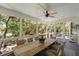 Screened porch with dining table offers a relaxing outdoor living area at 554 Parrot Point Dr, Charleston, SC 29412