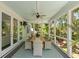 Screened porch with dining table and ceiling fan offers outdoor living space at 554 Parrot Point Dr, Charleston, SC 29412