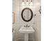 Charming powder room featuring shiplap walls, a round mirror, and a pedestal sink at 554 Parrot Point Dr, Charleston, SC 29412