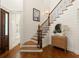 Elegant staircase with hardwood steps, iron railings, and shiplap walls, blending classic design with modern charm at 554 Parrot Point Dr, Charleston, SC 29412