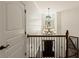 Elegant staircase with shiplap, wrought iron railing and a stylish chandelier at 554 Parrot Point Dr, Charleston, SC 29412
