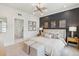 Elegant bedroom with a dark accent wall, paneled wood trim, and a comfortably styled bed at 566 Scholar Way, Summerville, SC 29486