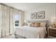 Comfortable bedroom with a plush bed, stylish headboard, decorative pillows, and bright natural light at 566 Scholar Way, Summerville, SC 29486