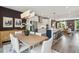 Bright, open-concept kitchen featuring stainless steel appliances, island seating, and hardwood floors at 566 Scholar Way, Summerville, SC 29486