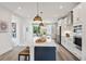 Modern kitchen with a large island, stainless steel appliances, and stylish pendant lighting at 566 Scholar Way, Summerville, SC 29486