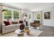 Bright living room with large windows, comfortable seating, and stylish decor at 566 Scholar Way, Summerville, SC 29486