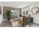 Cozy living room featuring stylish decor, wood paneled walls, and comfortable seating at 566 Scholar Way, Summerville, SC 29486