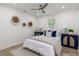 This bedroom features a ceiling fan, natural light, and decorative wall hangings at 6146 Chisolm Rd, Johns Island, SC 29455