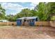 Charming blue home featuring a metal roof, wooden porch, and new wooden fence at 6146 Chisolm Rd, Johns Island, SC 29455