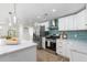 This well-equipped kitchen features stainless steel appliances, white cabinets, and quartz countertops at 6146 Chisolm Rd, Johns Island, SC 29455