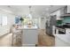 Open kitchen layout with bar seating, stainless appliances, and quartz counters offers modern charm at 6146 Chisolm Rd, Johns Island, SC 29455