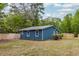 Side exterior view of the blue house with a new wooden fence at 6146 Chisolm Rd, Johns Island, SC 29455
