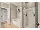 Clean bathroom with a walk-in shower, soaking tub, and white fixtures at 626 Windermere Blvd # 4D, Charleston, SC 29407