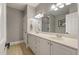 Bright bathroom featuring double sinks, white cabinetry, tile floors, and a large mirror at 626 Windermere Blvd # 4D, Charleston, SC 29407