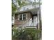 Charming brick two-story home with white railing leading to the front door and mature landscaping at 626 Windermere Blvd # 4D, Charleston, SC 29407