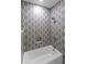This bathroom features a bathtub with a unique patterned tile surround, a showerhead, and built-in storage at 755 Adluh St, Mount Pleasant, SC 29464