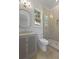 This bathroom features a single sink vanity, toilet, and walk-in shower with decorative tile and seamless glass door at 755 Adluh St, Mount Pleasant, SC 29464
