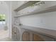 Bathroom with floating shelves and custom cabinets with rattan-style woven inserts at 755 Adluh St, Mount Pleasant, SC 29464