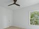 This bedroom features a light hardwood floor, a ceiling fan, and a window with leafy green outdoor views at 755 Adluh St, Mount Pleasant, SC 29464