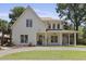 Charming two-story home with a front porch, well-manicured lawn and beautiful landscaping at 755 Adluh St, Mount Pleasant, SC 29464