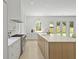Bright, spacious kitchen featuring a large island, modern appliances, and seamless flow to outdoor spaces at 755 Adluh St, Mount Pleasant, SC 29464