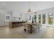 Open-concept kitchen and dining area with a large island, modern lighting, and backyard access at 755 Adluh St, Mount Pleasant, SC 29464