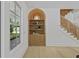 Stylish built-in shelving and woven-accent staircase add character to this bright living space at 755 Adluh St, Mount Pleasant, SC 29464