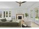 Bright living room with fireplace, white armchairs, and comfortable seating at 755 Adluh St, Mount Pleasant, SC 29464