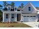 Attractive, light-pink, single-story home boasting a two-car garage, and inviting front porch at 761 Maynard Ln, Summerville, SC 29486