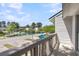 Scenic view from the balcony overlooking a community lake with lush greenery and blue sky at 7838 Nummie Ct, North Charleston, SC 29418