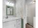 Cozy bathroom with a white vanity, marble countertop, and a patterned wallpaper at 7838 Nummie Ct, North Charleston, SC 29418