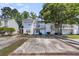 Charming two-story townhouse featuring a balcony, a well-maintained lawn, and convenient parking spaces at 7838 Nummie Ct, North Charleston, SC 29418