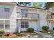 Charming two-story townhome featuring a balcony and a well-maintained front yard with a sidewalk leading to the front door at 7838 Nummie Ct, North Charleston, SC 29418